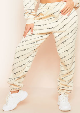 Eliora Cream Missy Empire Repetitive Slogan Joggers Eliora Cream Missy Empire Repetitive Slogan Joggers