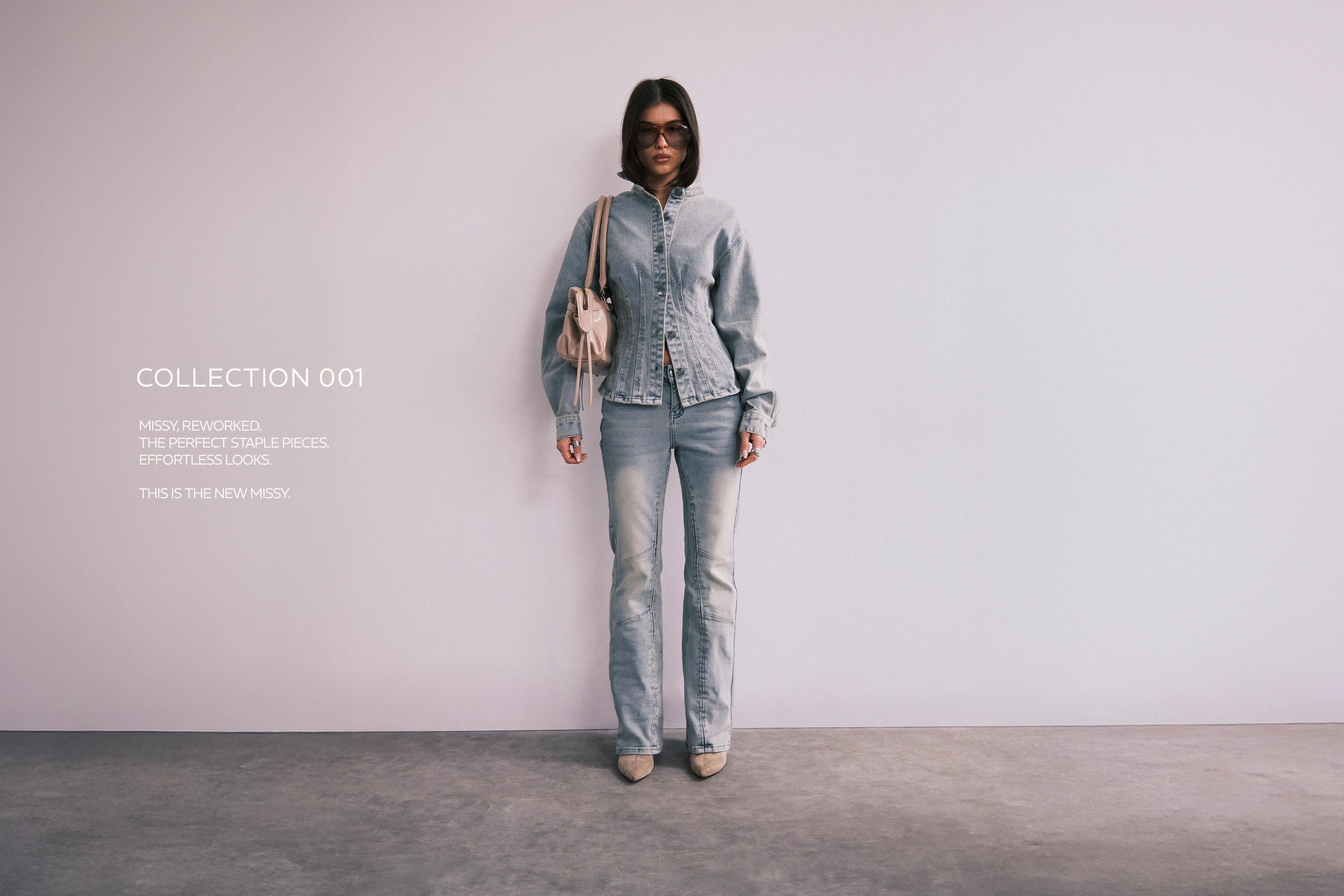 Person wearing a denim outfit with a plain background and text overlay.